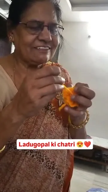 Nani crocheting a small orange piece by hand